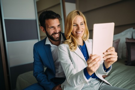 Business colleagues taking selfie on business tripの写真素材