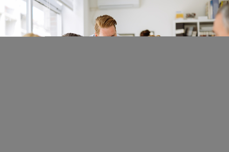 Businesspeople collaborating and talking through new ideas in office