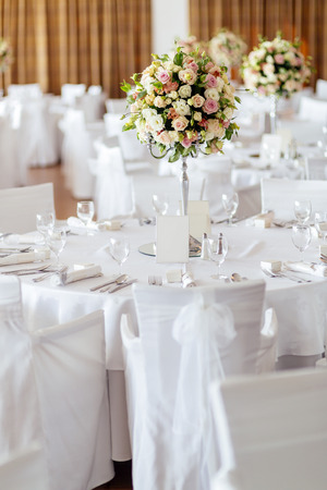 Beautiful wedding tables and roses in bouquetの写真素材