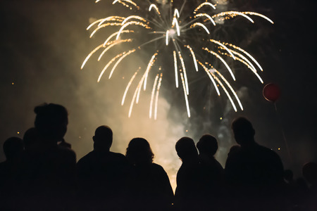 Crowd wathcing fireworks and celebratingの写真素材