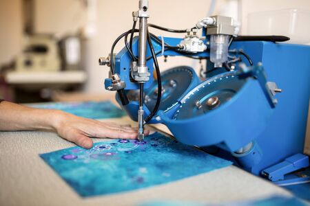 Precision machine attaching decoration stones to textileの写真素材