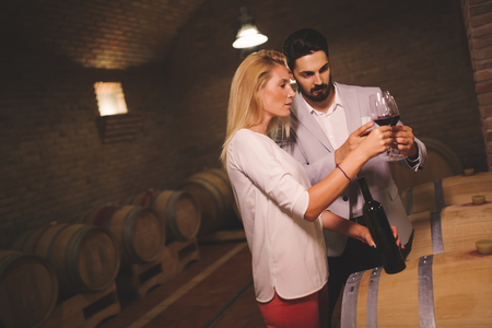 People tasting wine in winery basementの写真素材