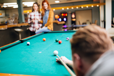 Snooker player aiming at billiard table