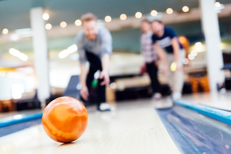 Friends enjoying recreational  bowling at clubの写真素材