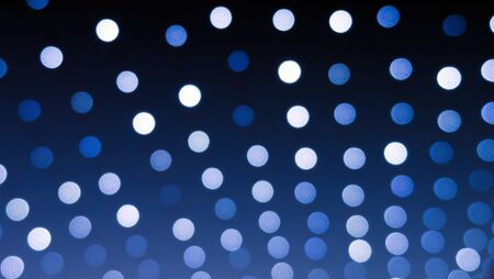 Defocused xmas  lights at night making white bokehの写真素材
