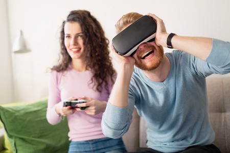 Couple having fun playing with virtual realityの写真素材