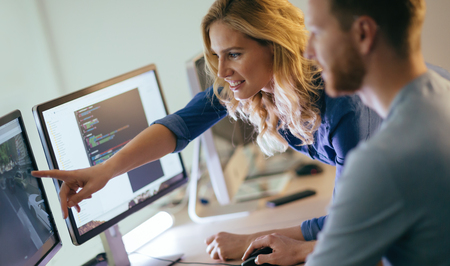Programmers cooperating at  IT company developing apps