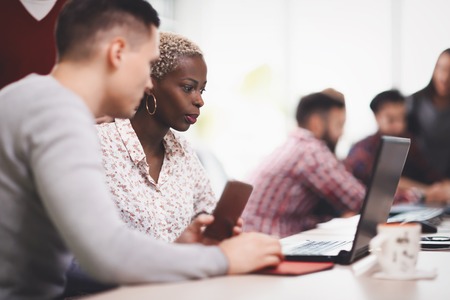 Programmers cooperating at  IT company developing appsの写真素材