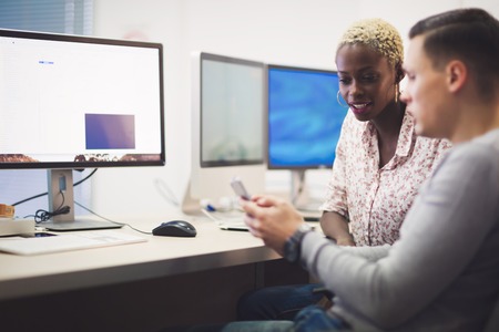 Programmers cooperating at  IT company developing appsの写真素材