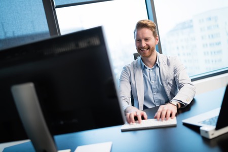 Successful businessman at his working desk in office