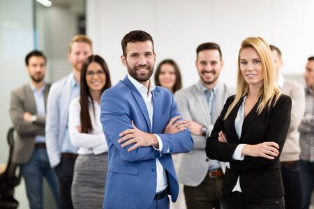 Happy business people celebrating success at companyの写真素材