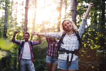 Group of backpacking hikers friends going for forest trekkingの写真素材