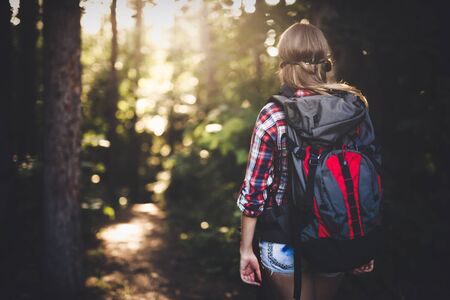 Female backpacker set out on forest hike advantureの写真素材