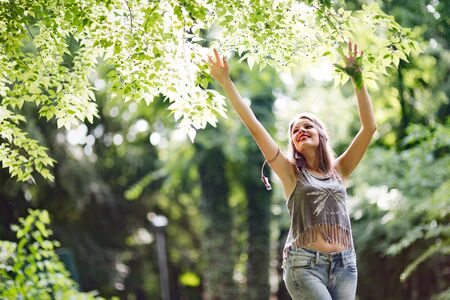 Beautiful happy woman speding time in green natureの写真素材