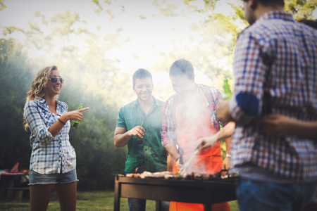 Happy people having camping and having bbq party outdoorの写真素材