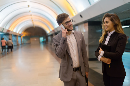 Couple talking while waiting for subway undergroundの写真素材