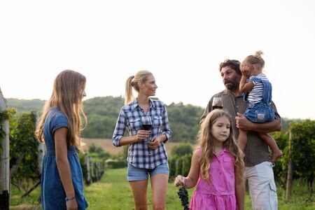 Happy winegrower family in vineyard before harvestingの写真素材