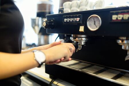 Professional barista preparing coffee with coffee machineの写真素材