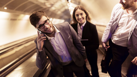 Coworkers using subway stairs together to get undergroundの写真素材