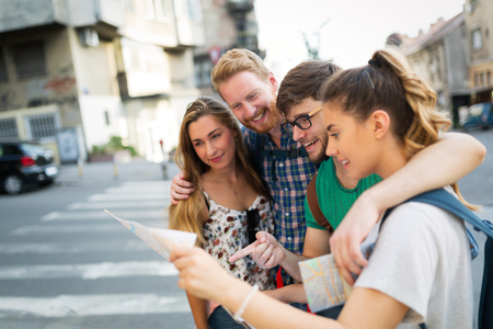 Tourist group of  friends discovering city on foot and travellingの写真素材