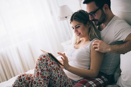 Couple in love with true emotions looking at tabletの写真素材