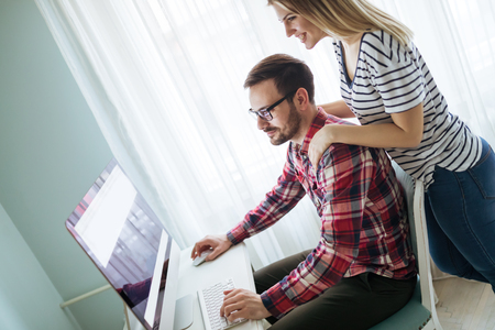 Supportive woman caring for husband working from homeの写真素材