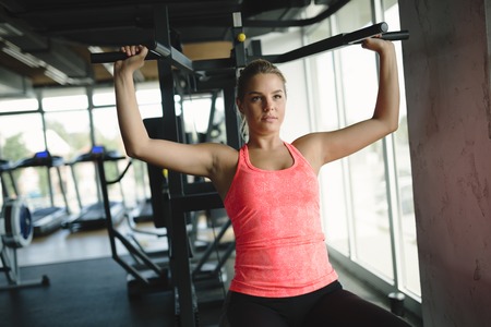 Athletic woman having fitness training and workout in gym