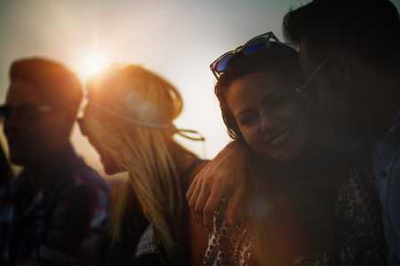 Romantic couple in love hugging in beautiful sunsetの写真素材