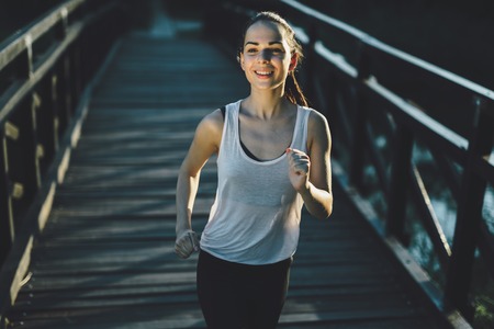 Beautiful sportswoman training and running outdoorsの写真素材