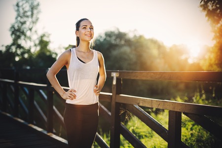 Beautiful sportswoman training and running outdoors