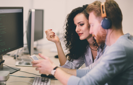 Programmers cooperating at  IT company developing appsの写真素材