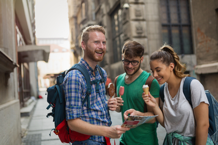 Travelling young people sightseeing and eating ice creamsの写真素材