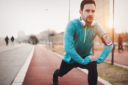 Handsome man stretching before exercising and runningの写真素材