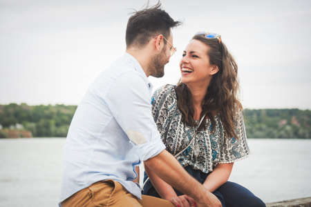 Happy beautiful couple in love smiling and laughing outdoorsの写真素材