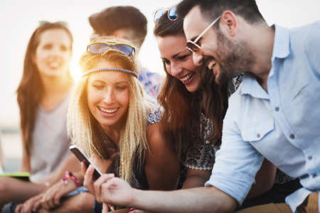 Group of friends having fun outdoors and are happyの写真素材
