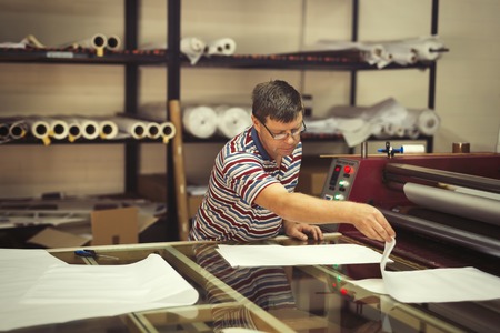 Worker working on fabric spreading machine in fabric industry