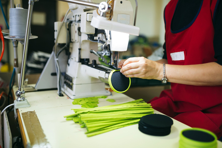 Woman working in sewing industry on machineの写真素材