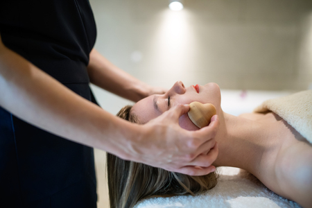 Relaxing anti stress facial massage at resortの写真素材