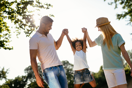 Playful faimly outdoors walking and smilingの写真素材