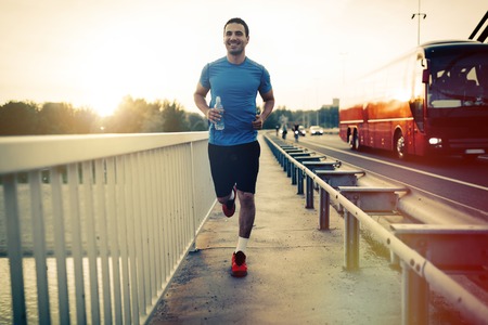 Fit athlete running outdoors to stay healthyの写真素材
