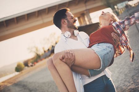 Truly happy playful couple in love  having fun at beachの写真素材