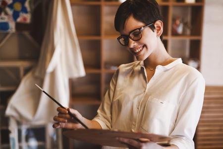 Creative pensive art school painter working on painting projectの写真素材