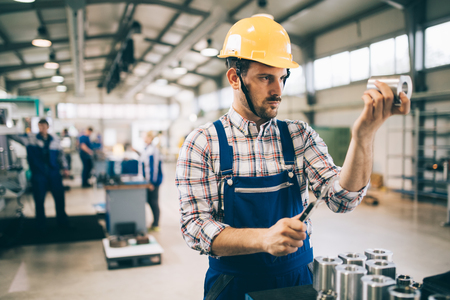 modern industrial machine operator working in metal industry factoryの写真素材