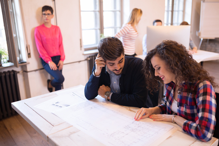 Business coworkers celebrate achieved goals in officeの写真素材