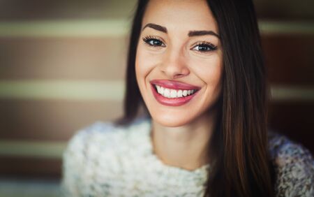 Attractive and beautiful woman smiling and posing to cameraの写真素材