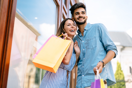 Happy attractive loving couple enjoy shopping togetherの写真素材