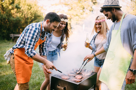 Friends spending time in nature and having barbecueの写真素材