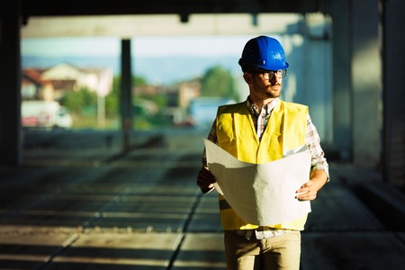 Picture of construction site engineer looking at planの写真素材
