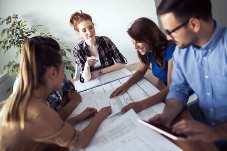 Image of business partners discussing documents and ideas