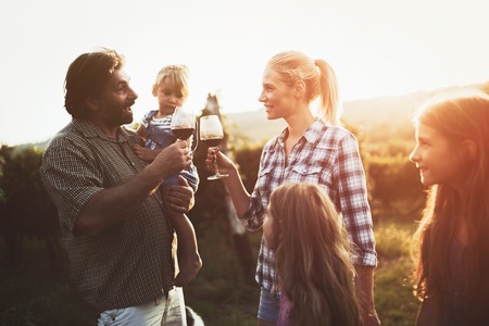 Winemaker family together in vineyard